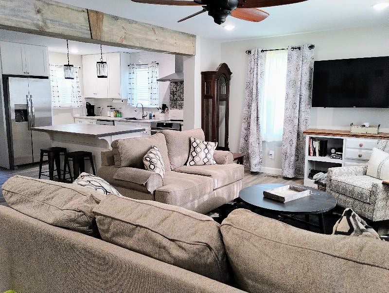 Open concept living room dining room and kitchen. This view is from the front door through the living room to the kitchen