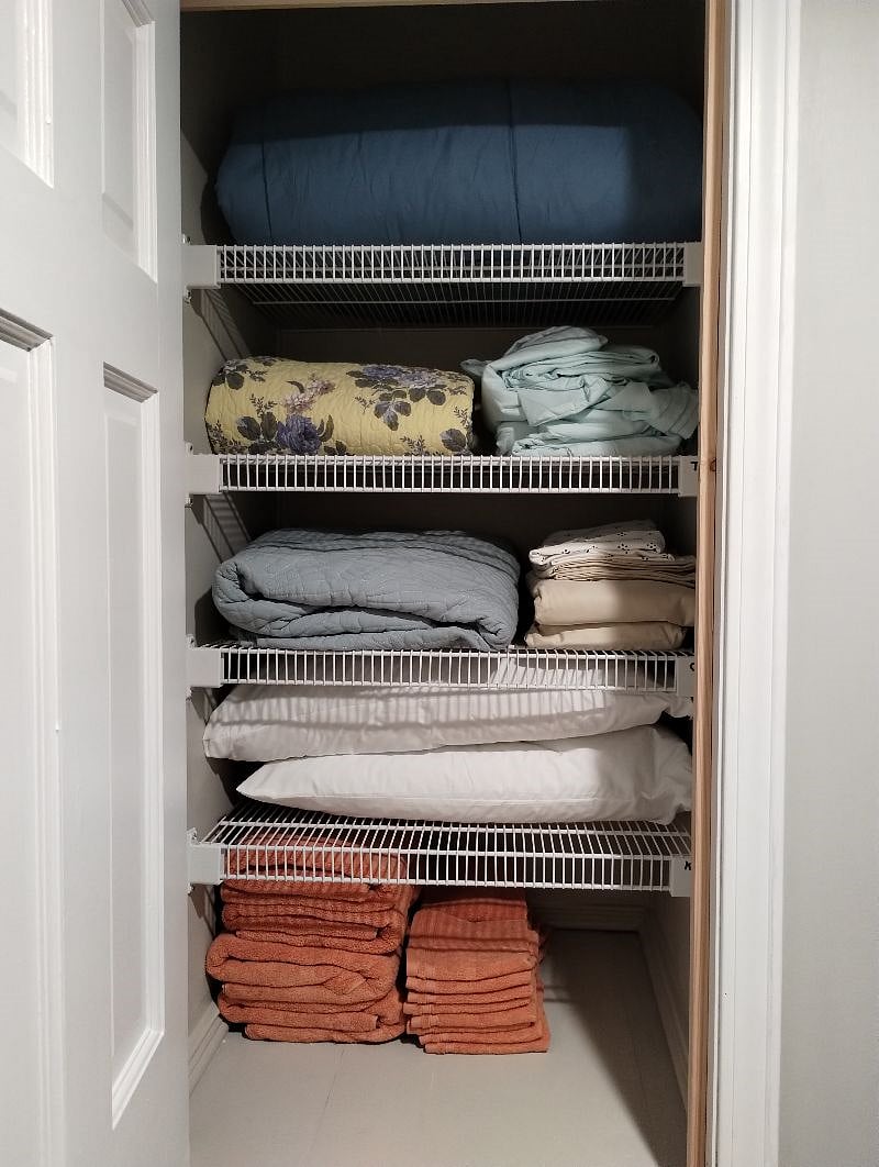Hall linen closet has extra sheets, blankets, pillows and towels