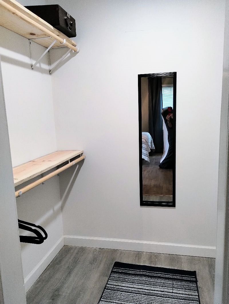 Large master bedroom walk-in closet has full length mirror and hangers