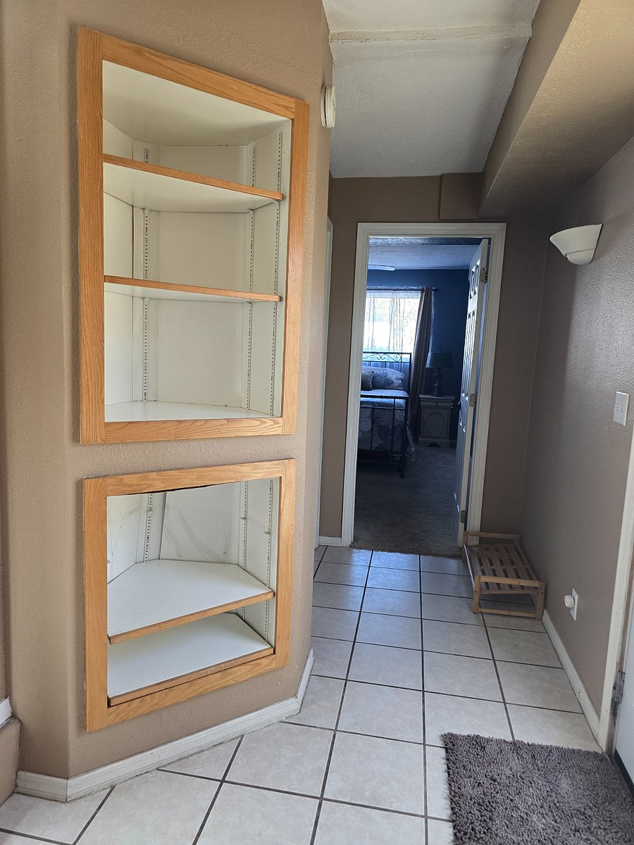 Hallway to Bedroom 2 with personal storage space