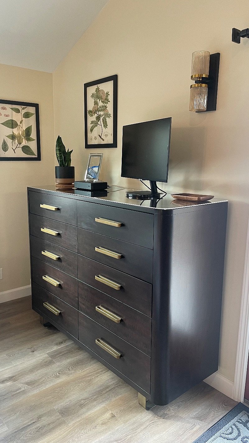 The huge, slow close Crate & Barrel dresser doubles as a TV stand.  Extra bedding is stored under the bed so you have full use of the dresser. 