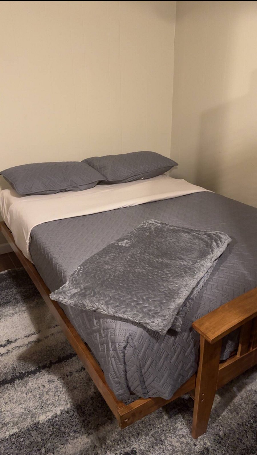 Bed double in den area by bathroom door Blackout curtains in room
