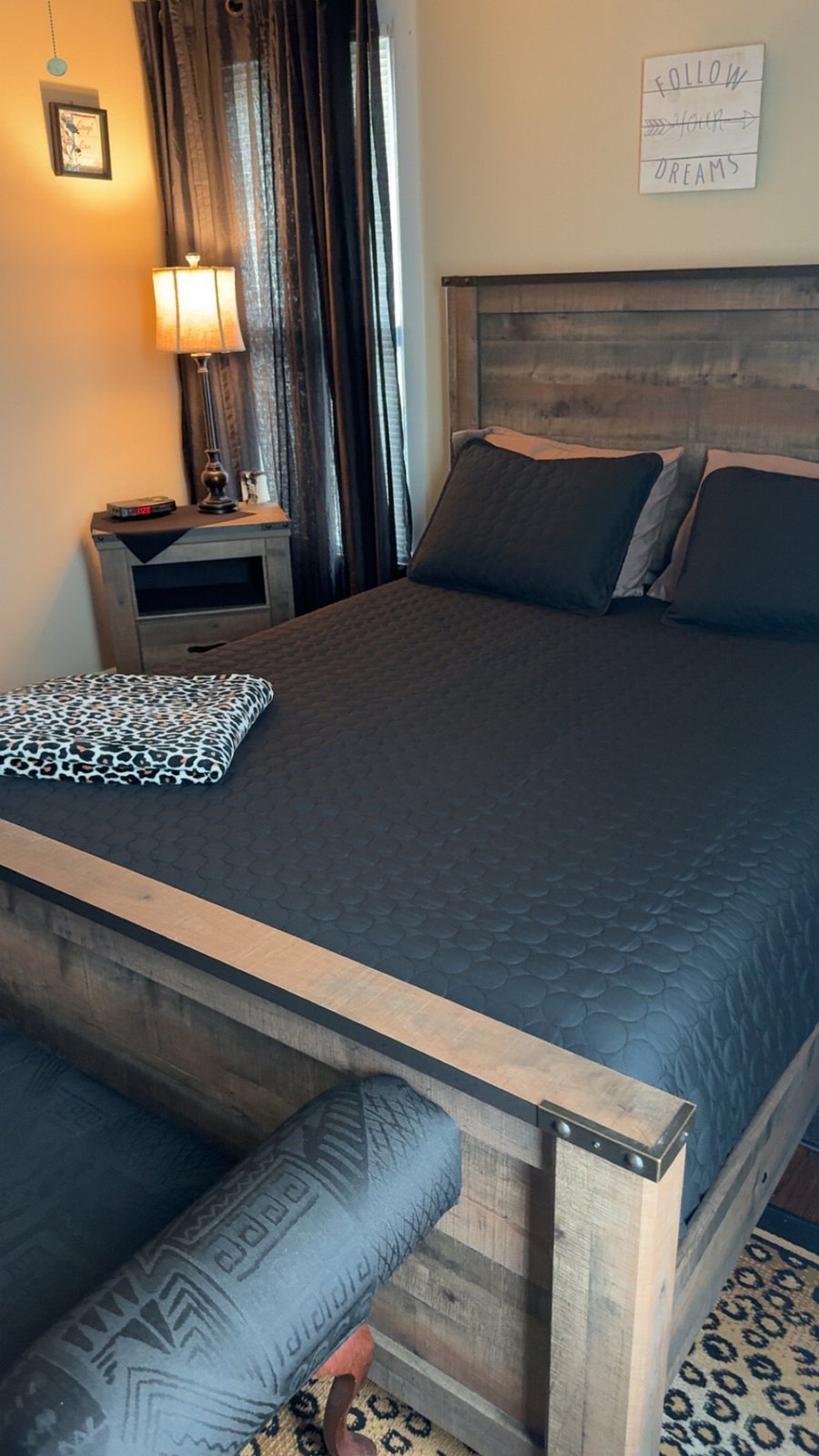 Queen bed across from full bathroom
