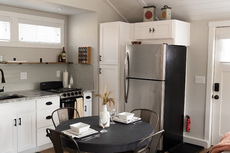 Dining table and kitchenette, full fridge