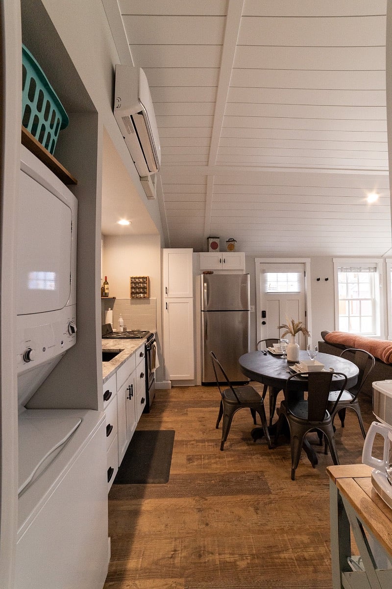 Kitchenette, dining area, front door, and (right side) living area from the bathroom
