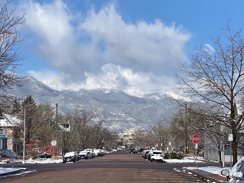 Looking west at Pikes Peak, obscured by clouds, from Dale St.