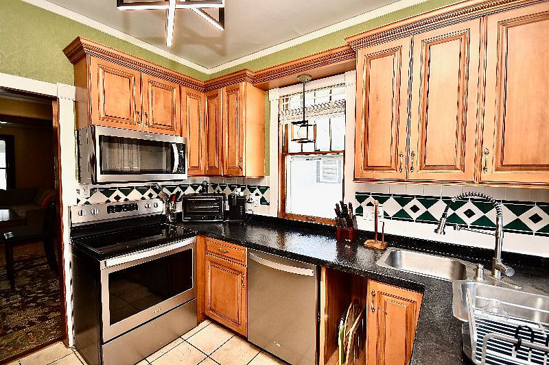 Kitchen:  Includes a full-sized fridge, range, microwave, air fryer, crockpot, and dishwasher. Essential cutlery, pots, and pans as well. 