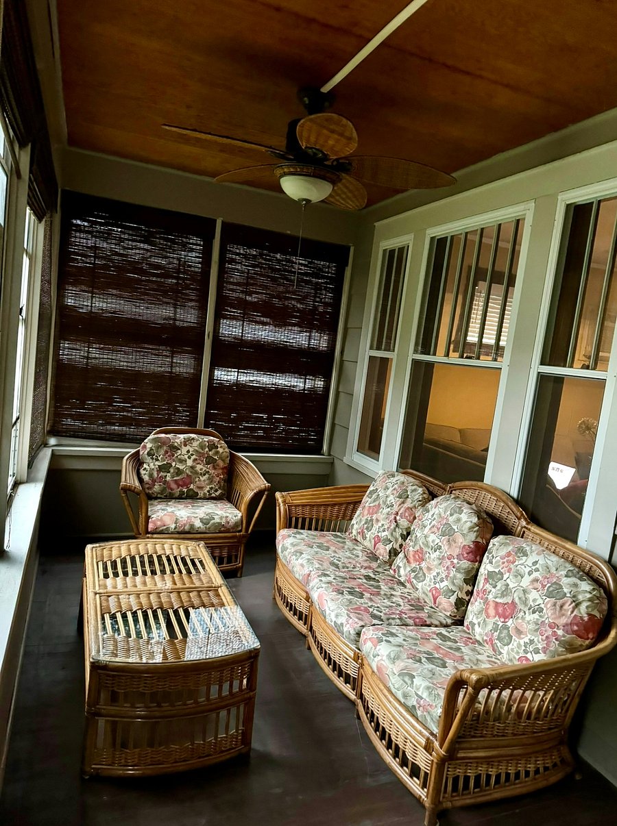 Three-season porch with cozy patio furniture. 
