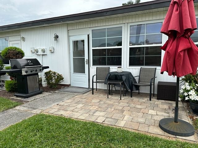 Back of Condo with patio and BBQ