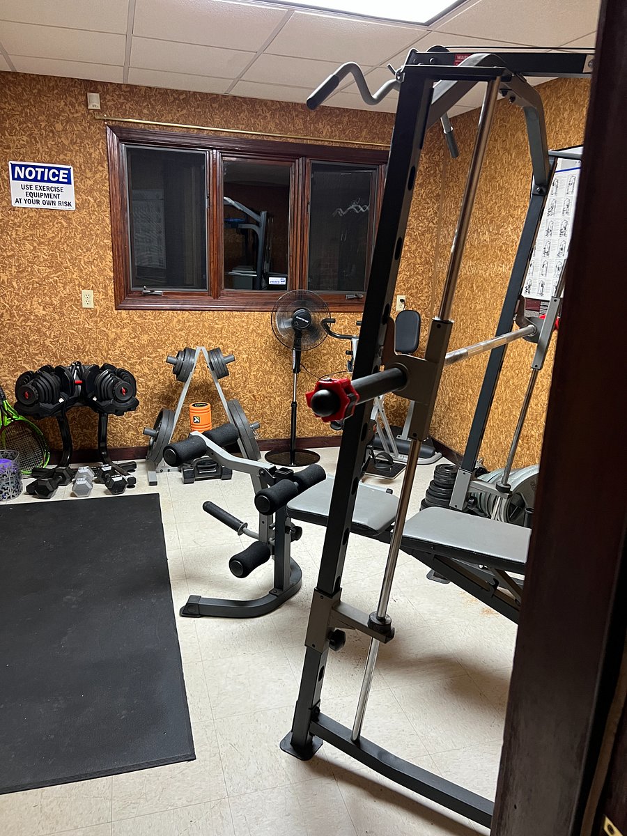 Exercise equipment in private gym room.