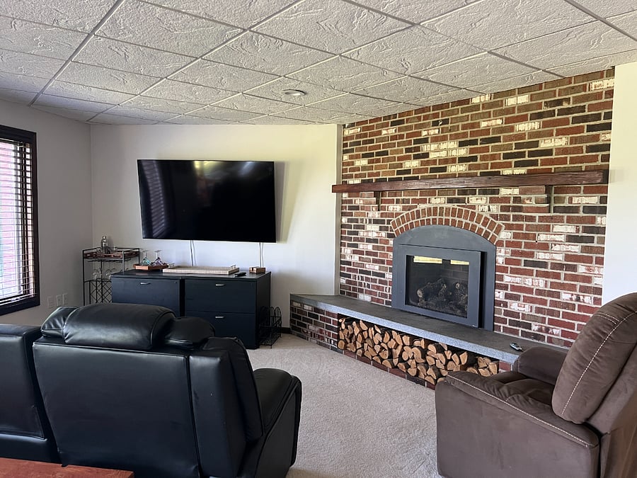 Living room with theater seating and propane fireplace.