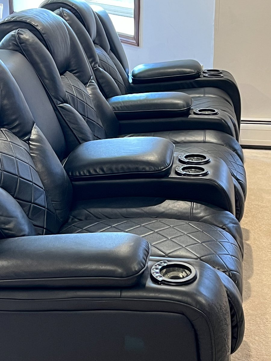 Theater style seating with cup holders and storage.