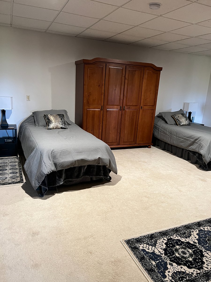 Large second bedroom with two twin adjustable beds with remotes. Large armoire for hanging clothes. Nightstands with lamps with plug and multiple usb outlets.