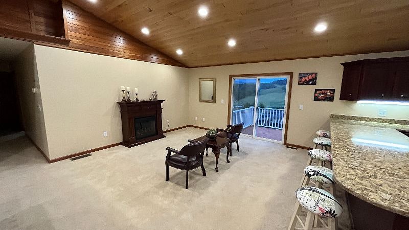 Additional Living Room seating with fireplace and sliding door to access the back deck.