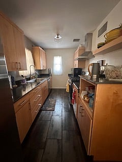 Kitchen with gas stove, refrigerator, microwave, dishwasher.