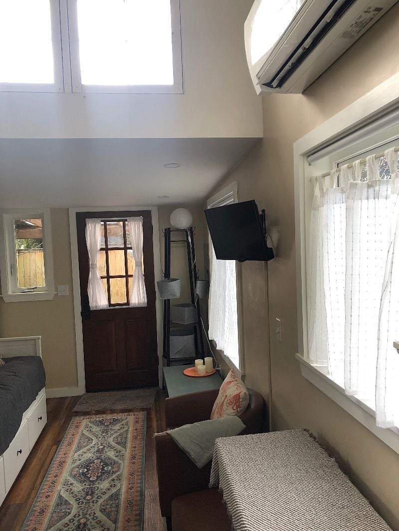 Coat rack, storage bench, TV, lounging chair, lots of light.