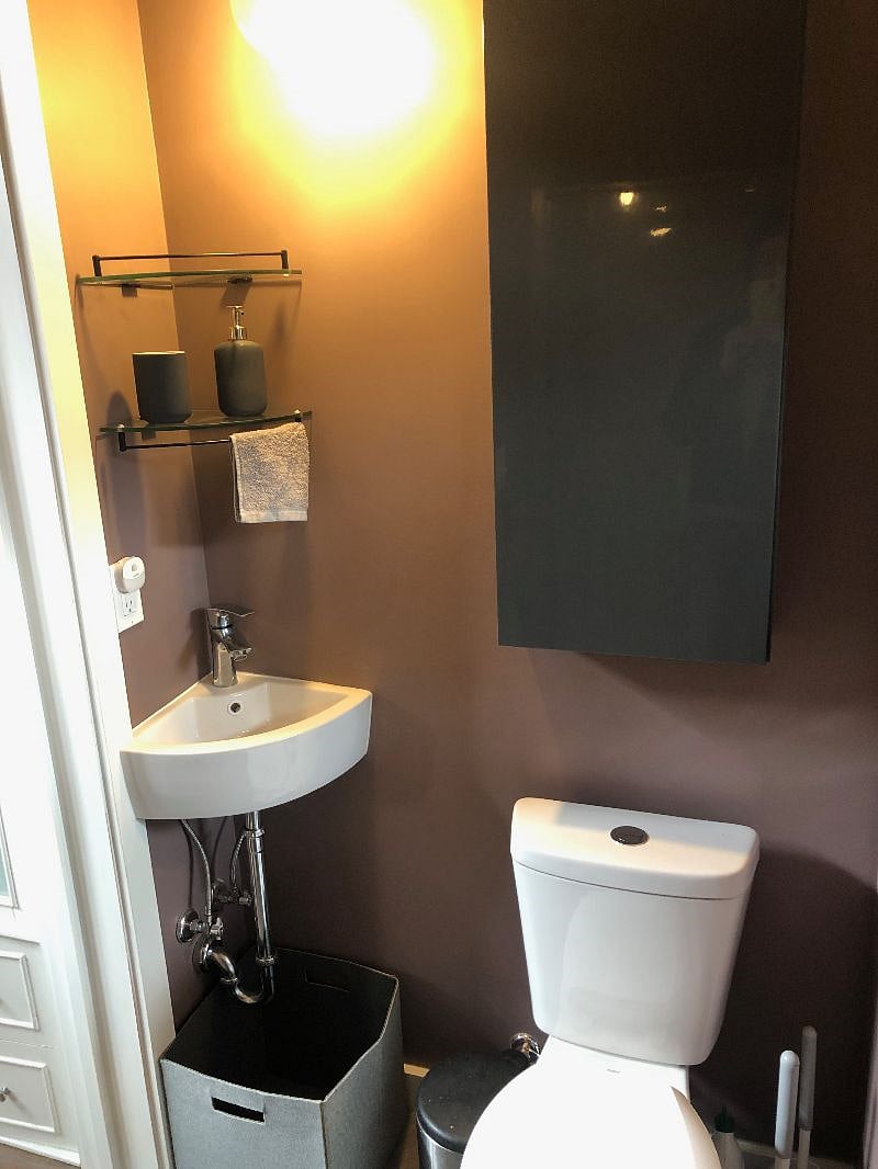 Toilet, sink, storage cabinet.