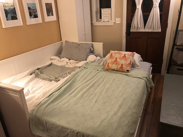 Bed set up for sleeping- king size with two twin mattresses next to each other.