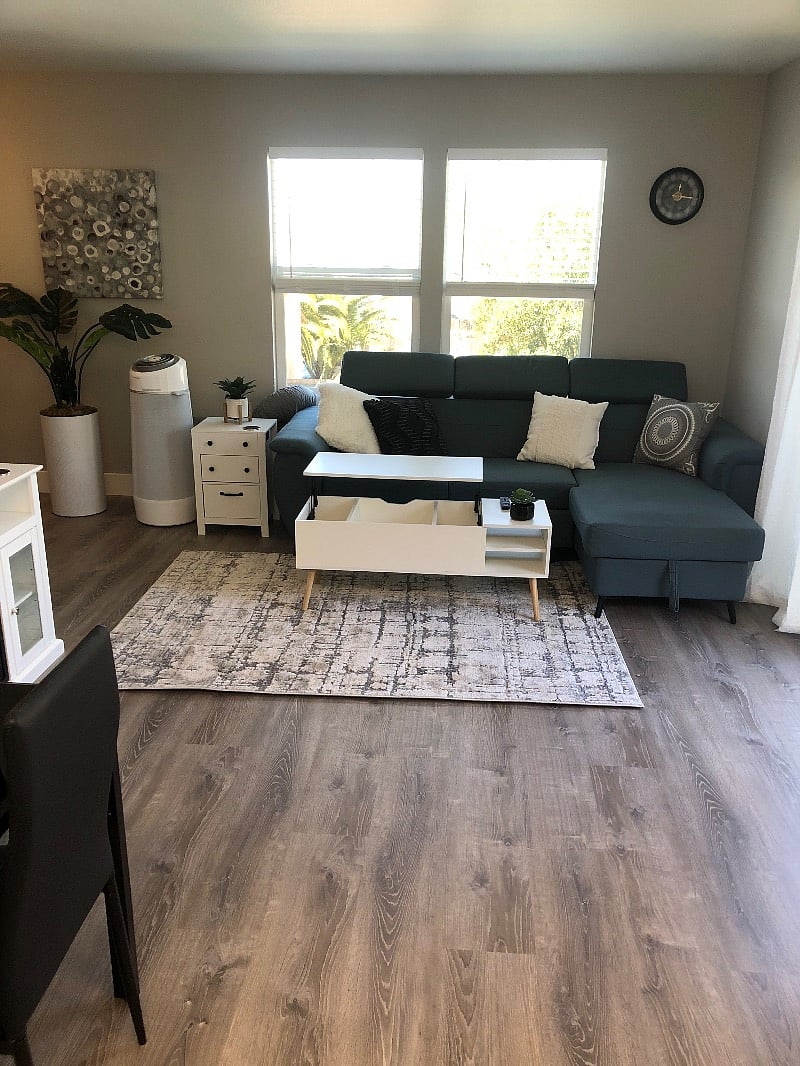 Coffee table has a lift top great for a lap top or dining at the couch.