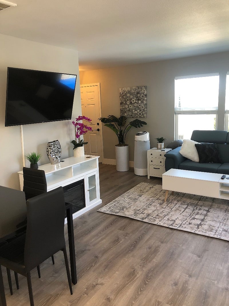 A cozy electronic fireplace build into the entertainment center with remote