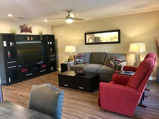 Living room with 2 massage/heated recliners, couch, 70" curve SmartTV