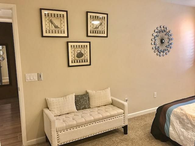Spacioius Queen Bedroom showing bench & wall art