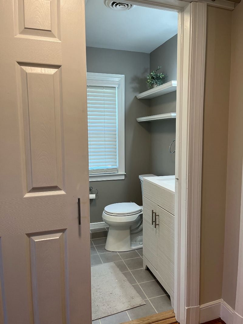 Upstairs full bathroom located at the top of the stairs between master bedroom and second bedroom