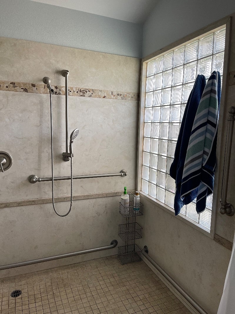 Large accessible shower and toilet with storage closet