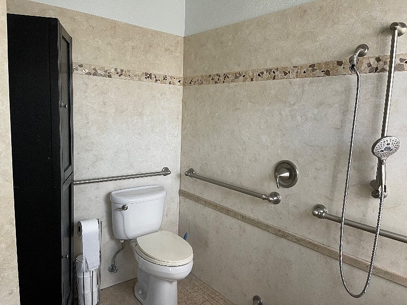 Large accessible shower and toilet with storage closet