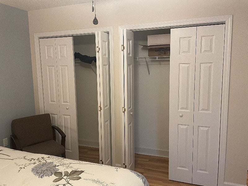 Double wall closets in the second guest room with a queen bed 