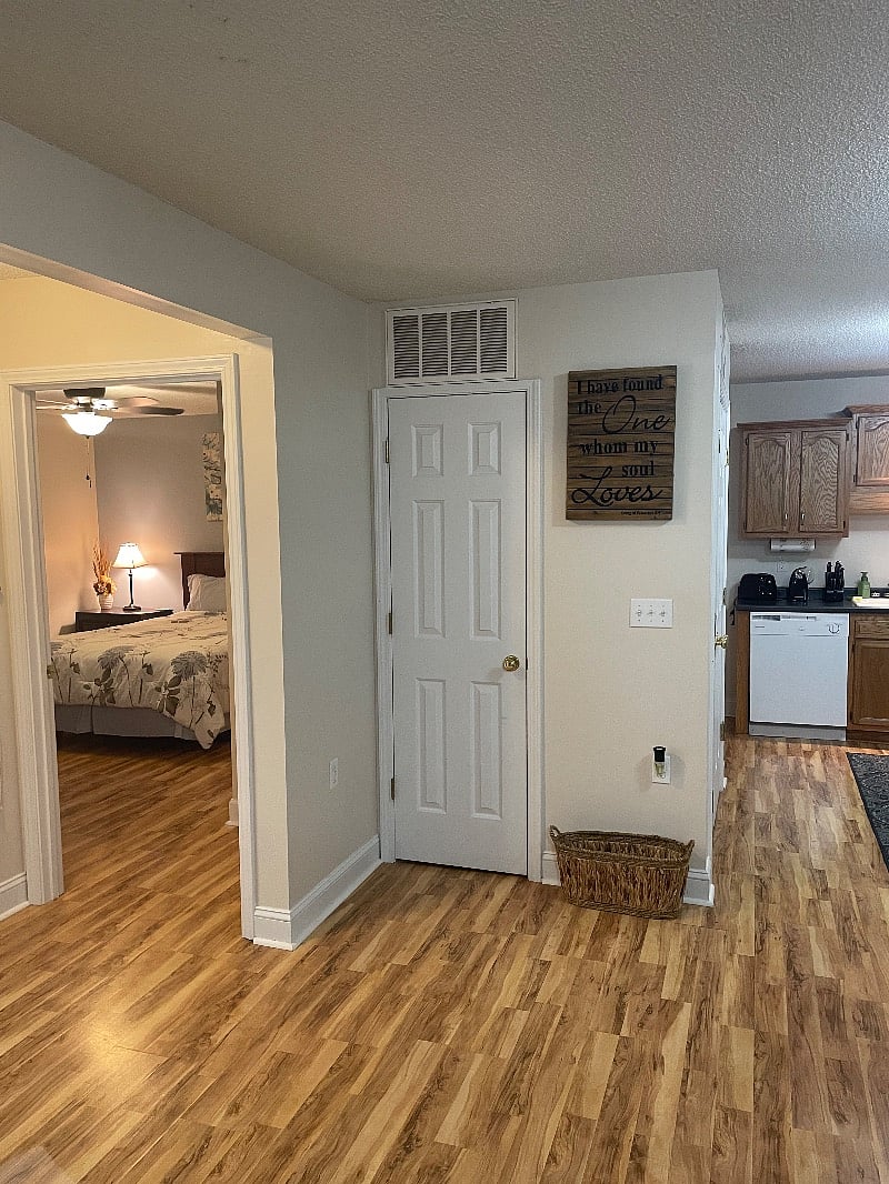 View from living room into the kitchen and guest bedroom storage closet for your things!