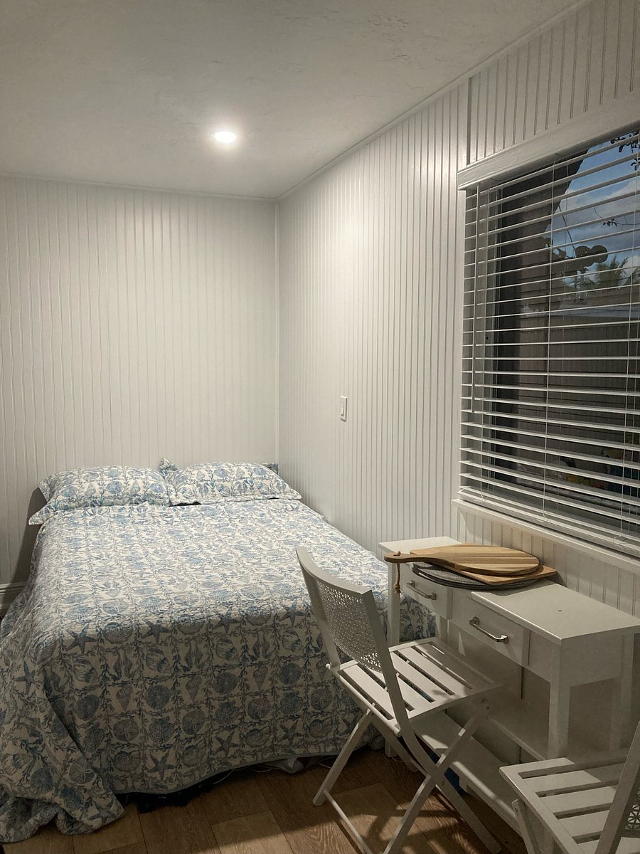 Full size bed, with large window facing orchid garden