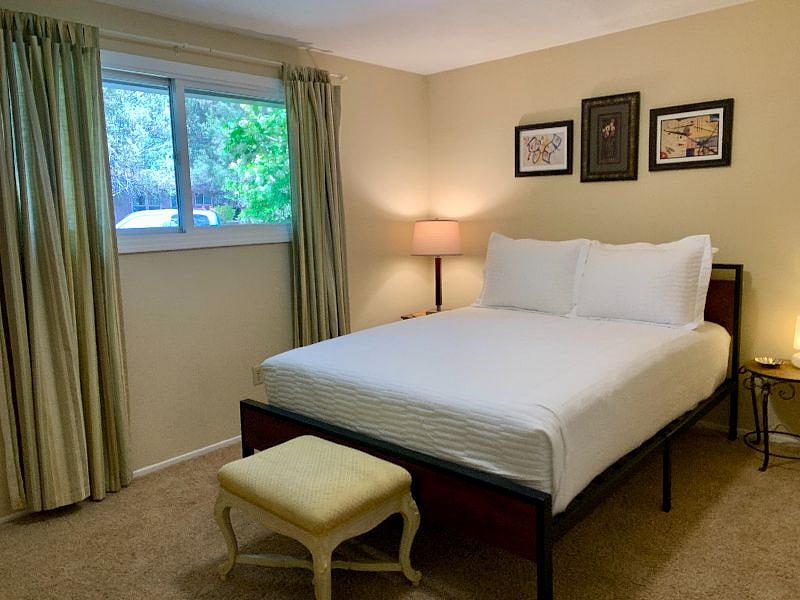 One of the three bedrooms, four pillows on all beds, new soft bedding, and high-end, extremely comfortable thick, queen mattresses. Double-door closets with built-in shelving for great storage.
