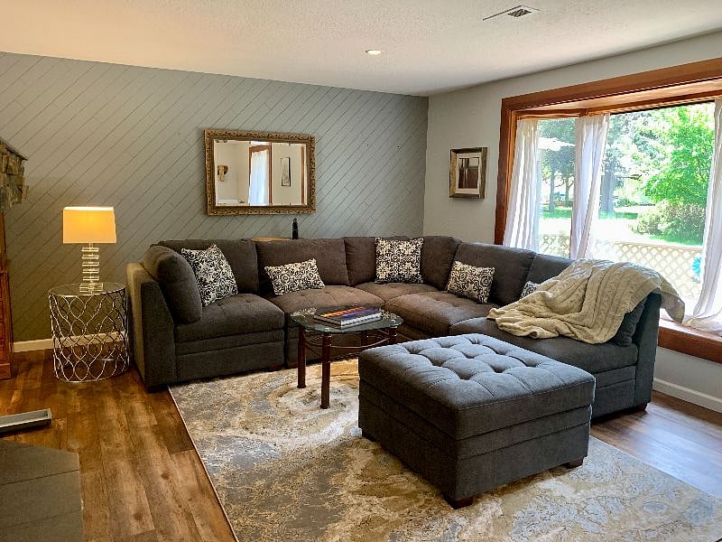 Living room is so easy to relax in. Large L shape couch and foot stool. Also, picture window with a bench seat to enjoy the view, gas fireplace, and smart tv on a mount that swivels, tilts and turns for your ultimate comfort.