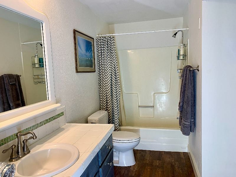 Second bathroom with tub, shower and large vanity. This bathroom also has the washer and dryer inside of it (not pictured)