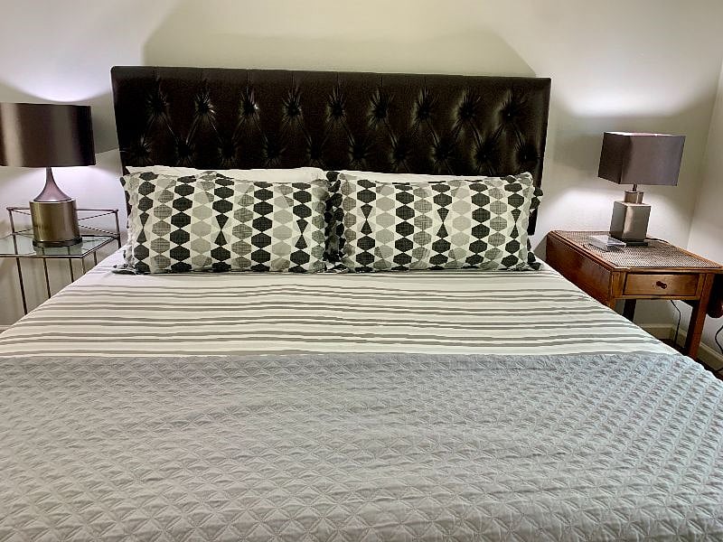 Soft king headboard, linens and bedside lighting for ultimate comfort.