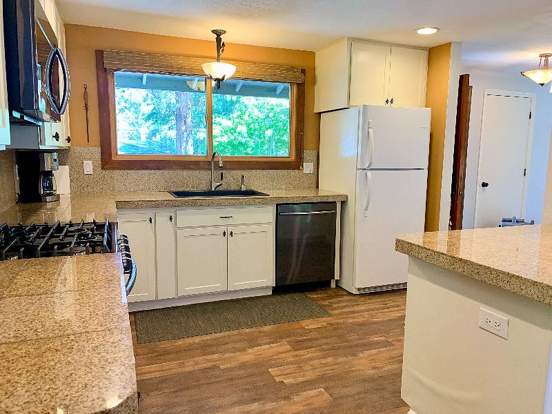 Insta-hot water at the large kitchen sink. Granite counters often watch the deer walk by the front yard.