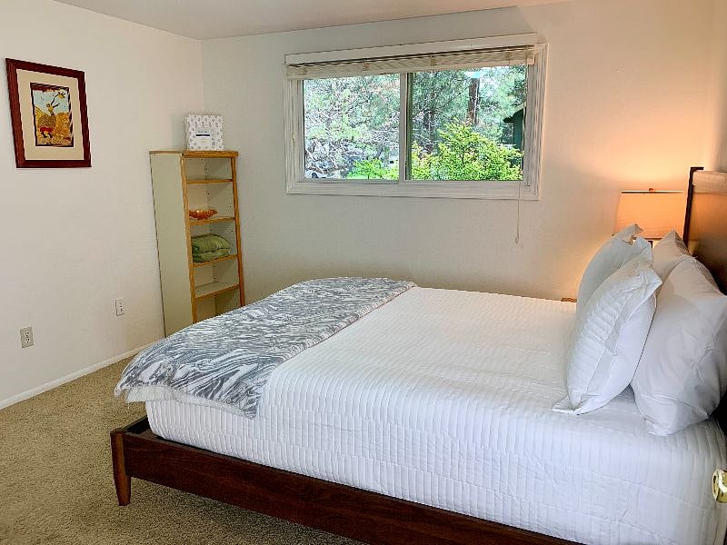 One of the three bedrooms with new high-end queen mattress and a gorgeous view out the windows. Large double door closet with built in shelving (not pictured).