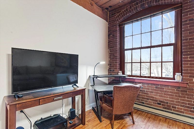 TV in living area and designated workspace for working from home