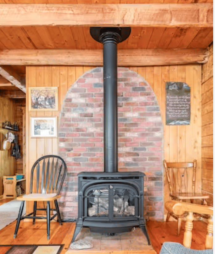 Propane "wood" stove with look-alike logs and flames. Propane is on auto delivery.