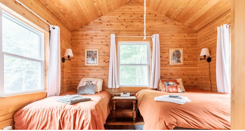 Larger bedroom with queen and twin beds. Sheets and pillows provided.