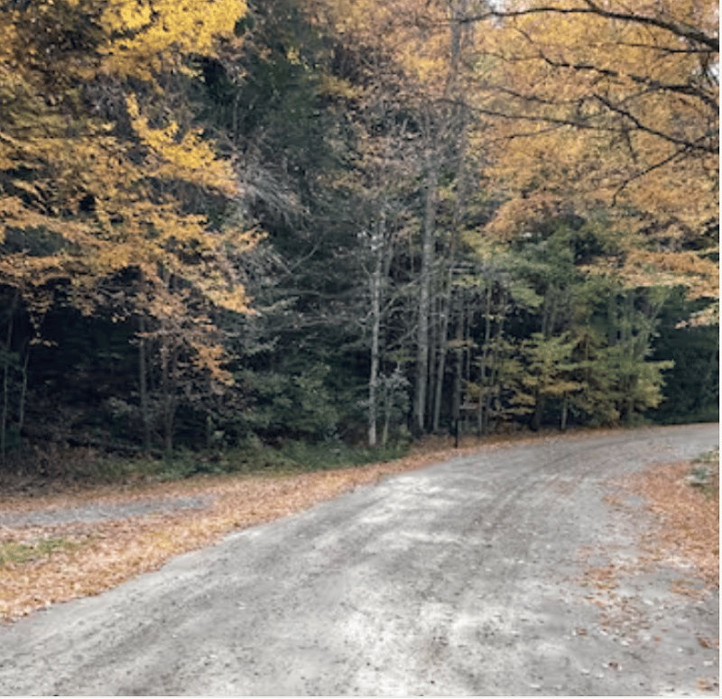 The cabin is up a very well maintained packed gravel road a mile off of Route 2.