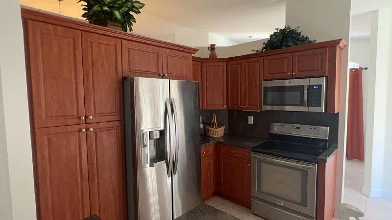 Open kitchen with stainless steel appliances.