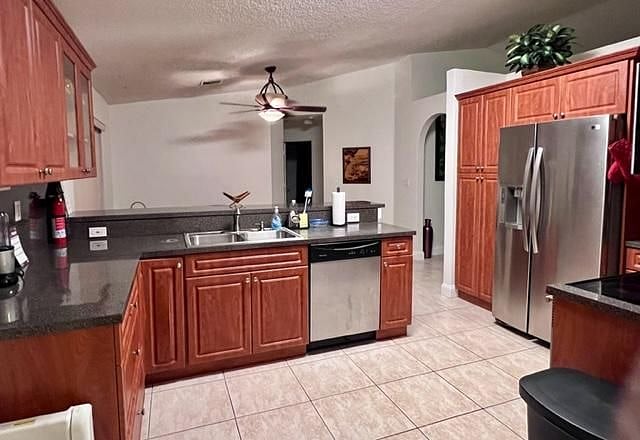 Open kitchen with stainless steel appliances, coffee maker, blender, toaster, cookware, dishware, silverware and glassware.