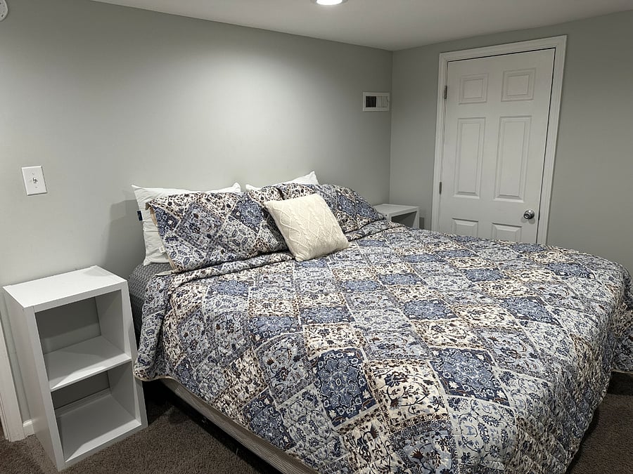 King bedroom in basement. Closet, storage bedside tables and large storage cubbies