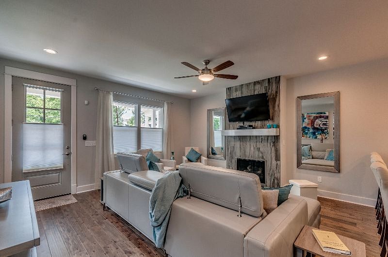 Living Room w/ Top down, Bottom up blind for privacy but still let light in. Designer couch with chaise.  Gas Fireplace