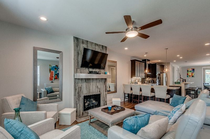Living area w/ reclining Mid Century Chairs, gas fireplace and 50 inch screen smart TV.  