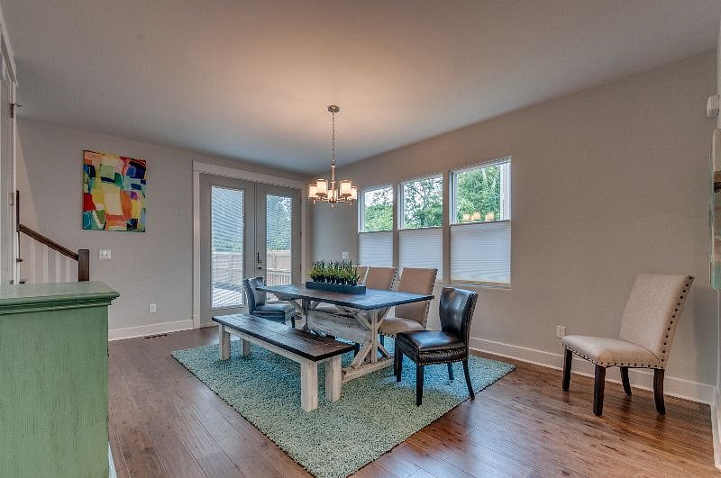 Custom Post Trestle Dining Table and Bench. Seats 8. Back door with entry pad and leads out to back patio. 
