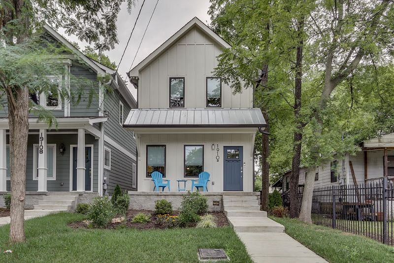 HOME. FRONT of house with covered patio and sitting area.