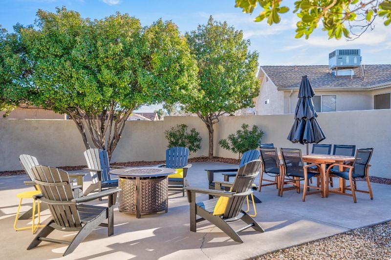 Back Patio offers a  fire-pit, outdoor dining table, covered patio and hot tub!